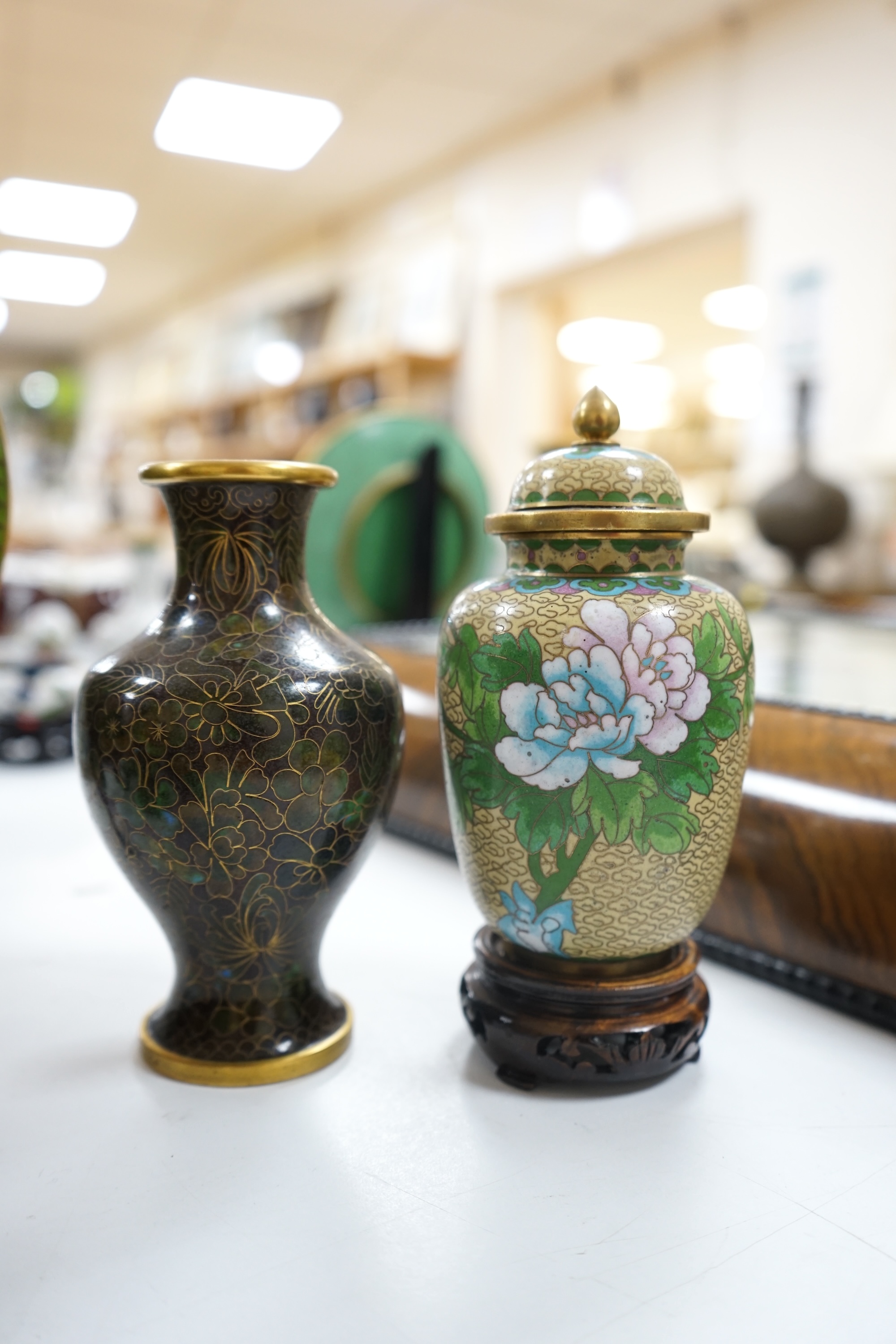 A collection of Chinese cloisonné enamel wares, with mixed coloured backgrounds, all with floral designs, some with stands, plate 21cm diameter. Condition - good